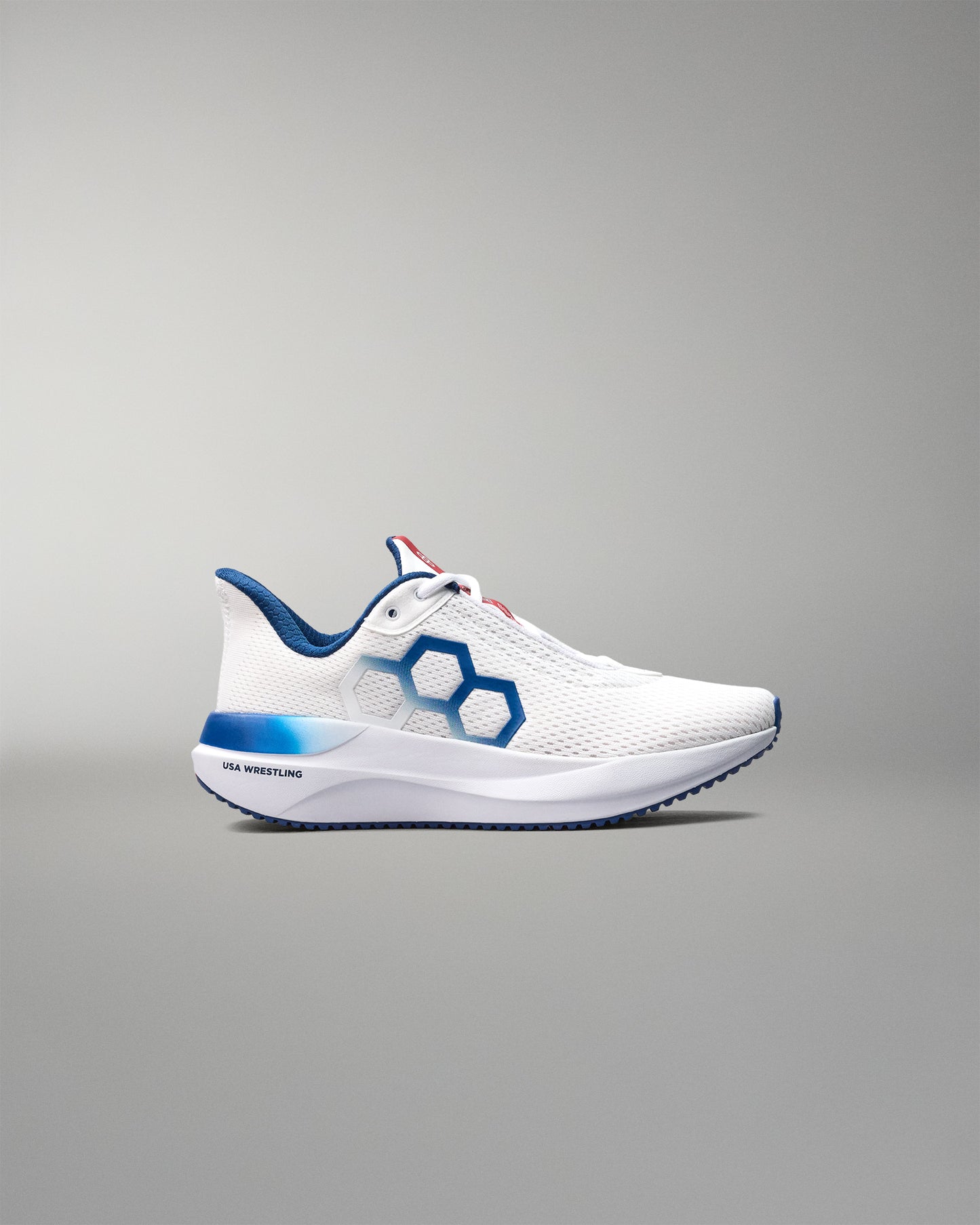 White athletic shoe with blue accents on a gray background