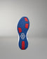 Blue and red sole of a shoe with a hexagonal pattern on a gray background