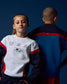 Two children wearing USA-themed athletic outfits against a dark blue background