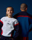 Two children wearing USA-themed athletic outfits against a dark blue background