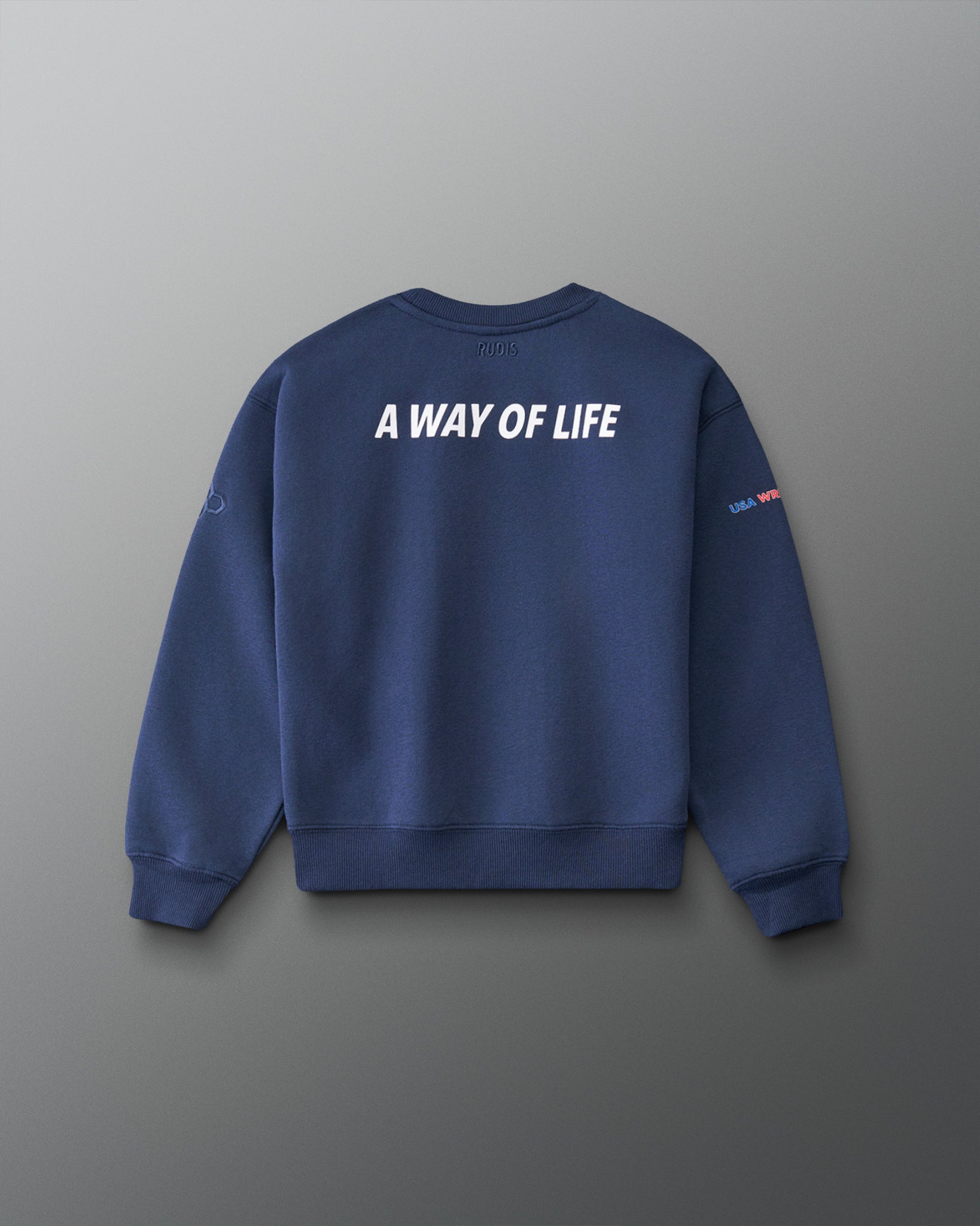 A navy blue crewneck sweatshirt shown from the back, featuring the phrase 'A WAY OF LIFE' printed in bold white capital letters across the upper back. The sweatshirt is displayed on a clean, dark gray gradient background.