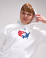 Person wearing a white hoodie with a logo on a gray background