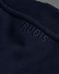Navy blue fabric with 'RUDIS' branding