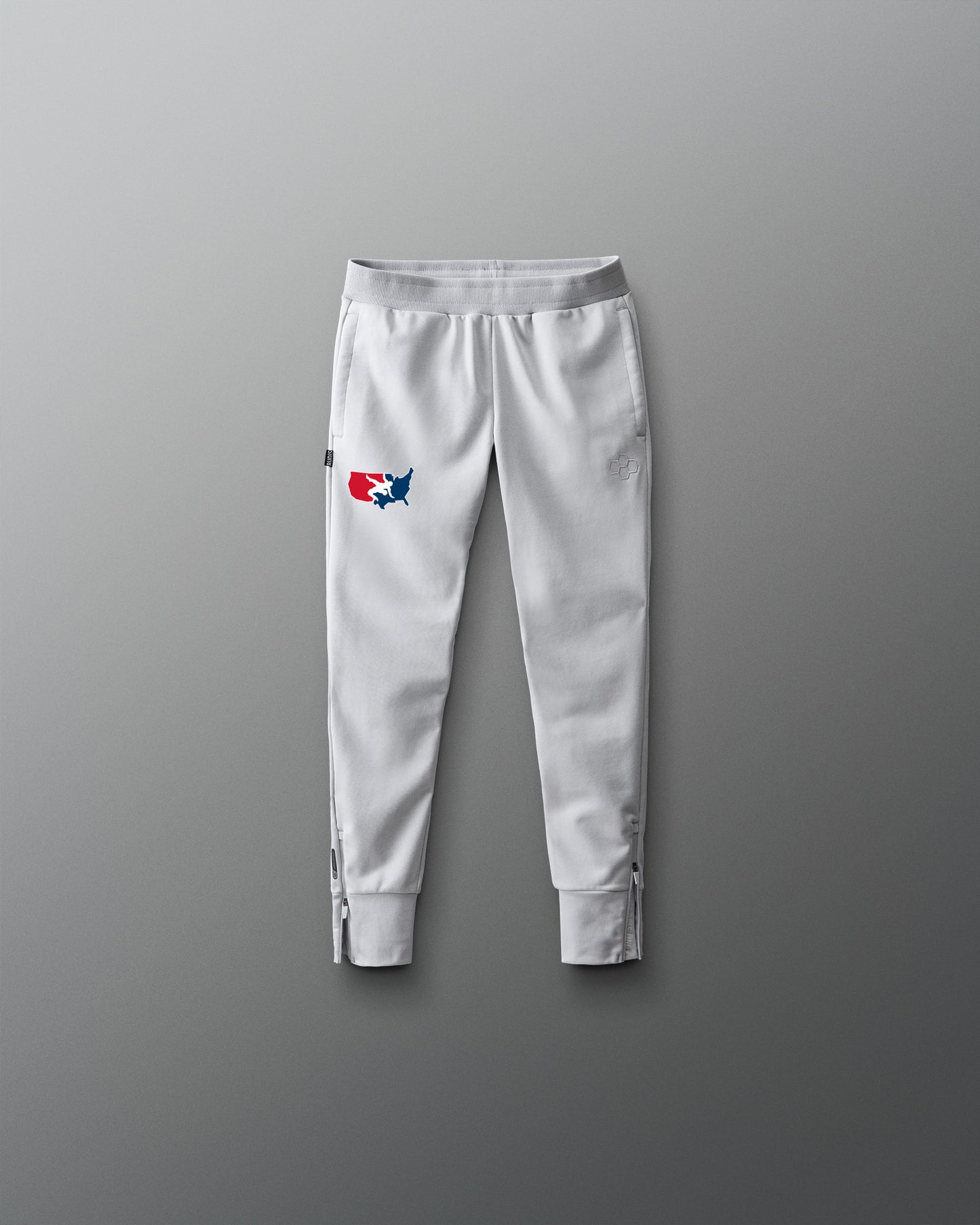 Light gray sweatpants with a logo on a gray background