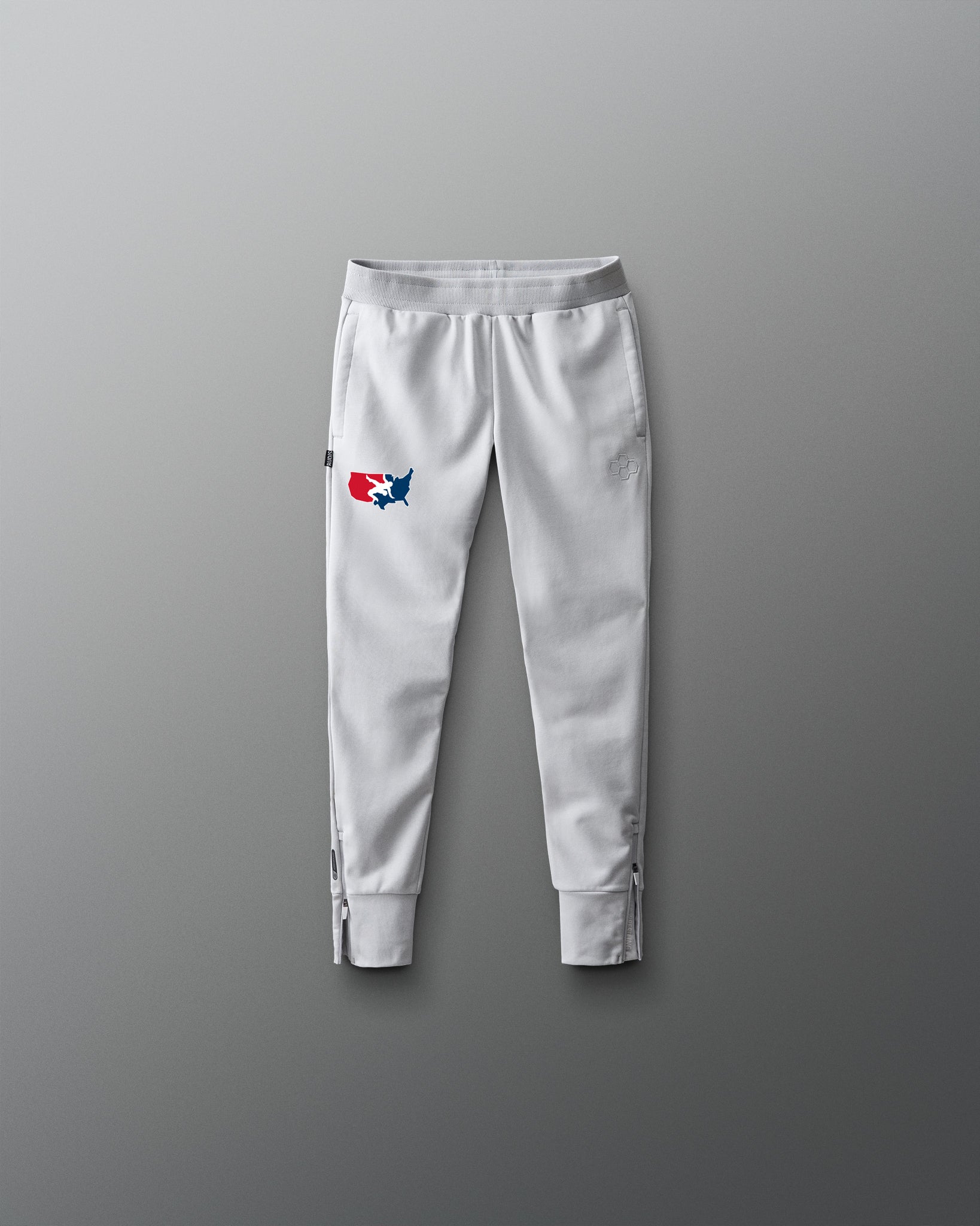 Light gray sweatpants with a logo on a gray background