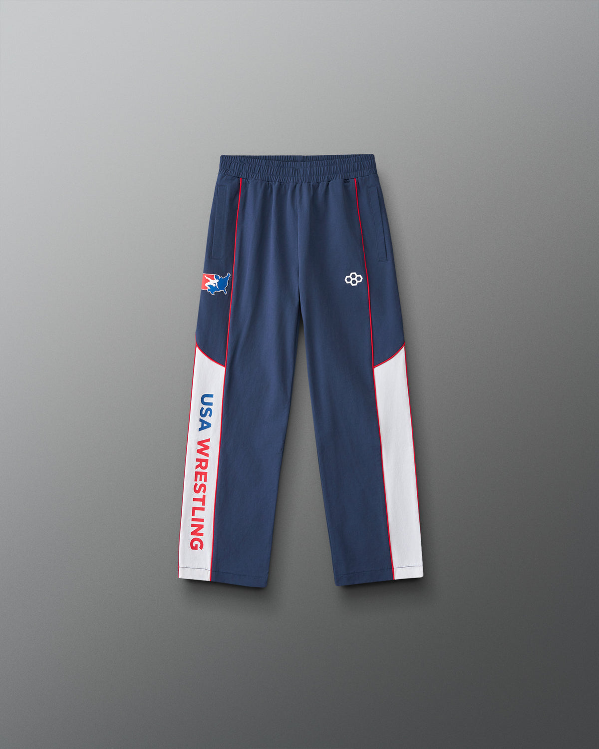 Front view of the RUDIS USA Wrestling Youth Movement Podium Pants in navy, featuring white side panels, red piping, USA Wrestling graphics, and RUDIS logo.