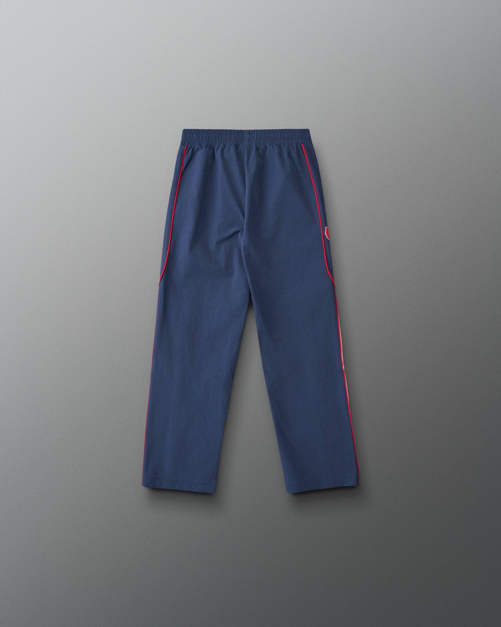 Back view of the RUDIS USA Wrestling Youth Movement Podium Pants in navy, featuring red piping, an elastic waistband, and a streamlined athletic design.
