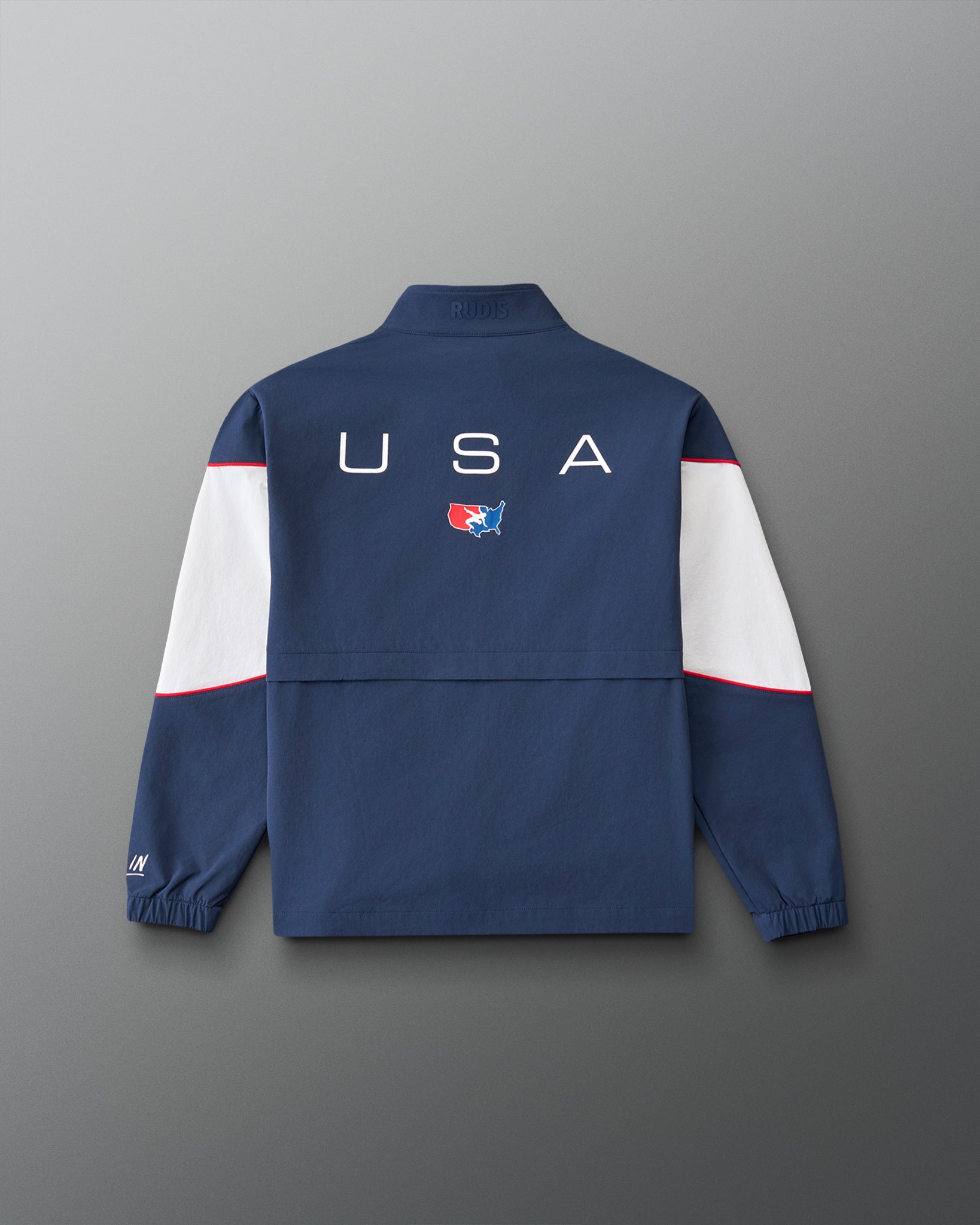Back view of the RUDIS USA Wrestling Full Zip Movement Podium Jacket in navy, featuring large USA lettering, USA Wrestling logo, white sleeve panels, and red piping.