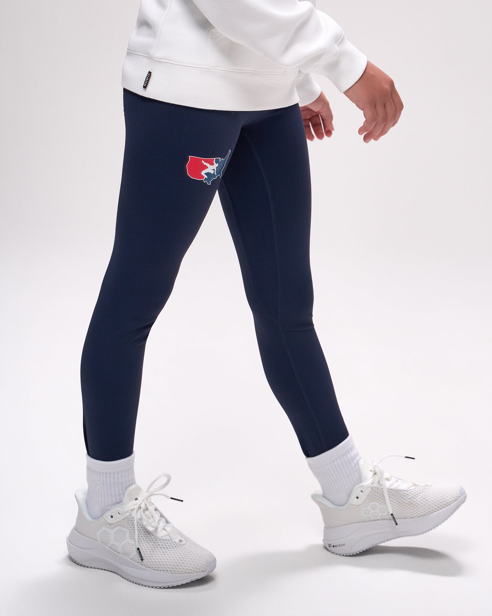 Navy leggings with a 'USA Wrestling' logo worn by a person on a white background