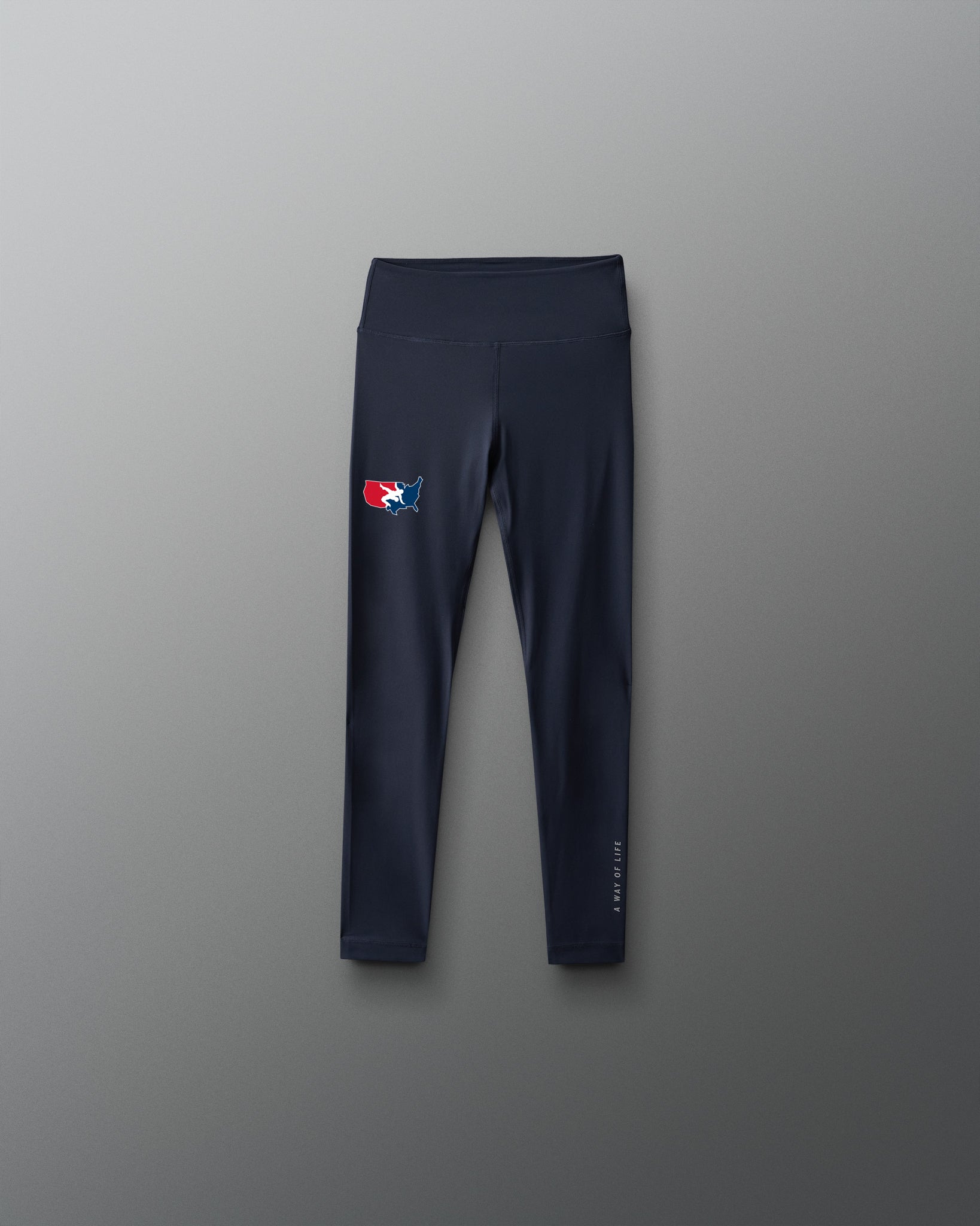 Navy leggings with a 'USA Wrestling' logo on a gray background