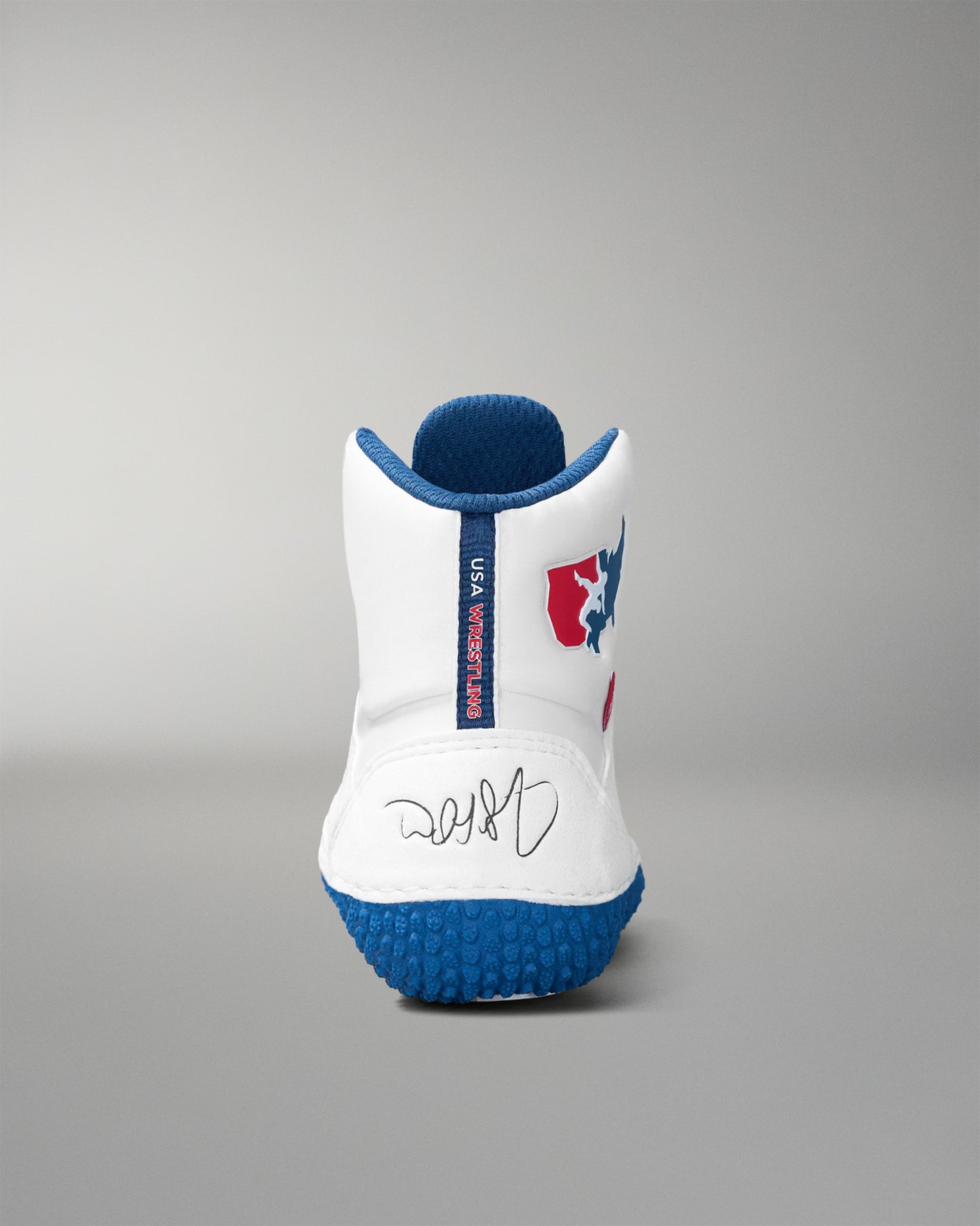 White and blue wrestling shoe with a logo on a gray background