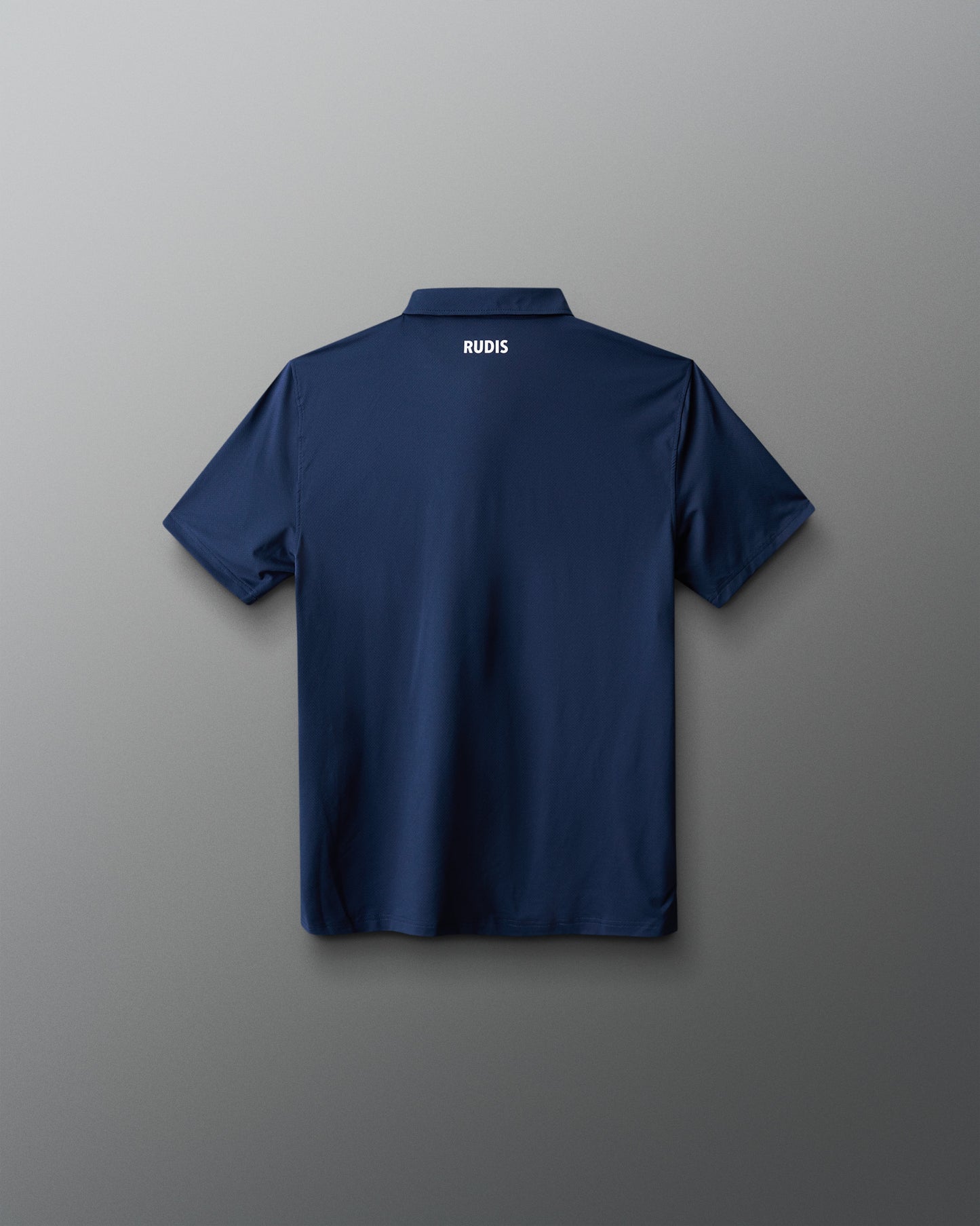 Navy blue polo shirt with 'RUDIS' branding on a gray background