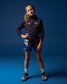 Young girl in RUDIS USA Wrestling sports attire posing against a blue background
