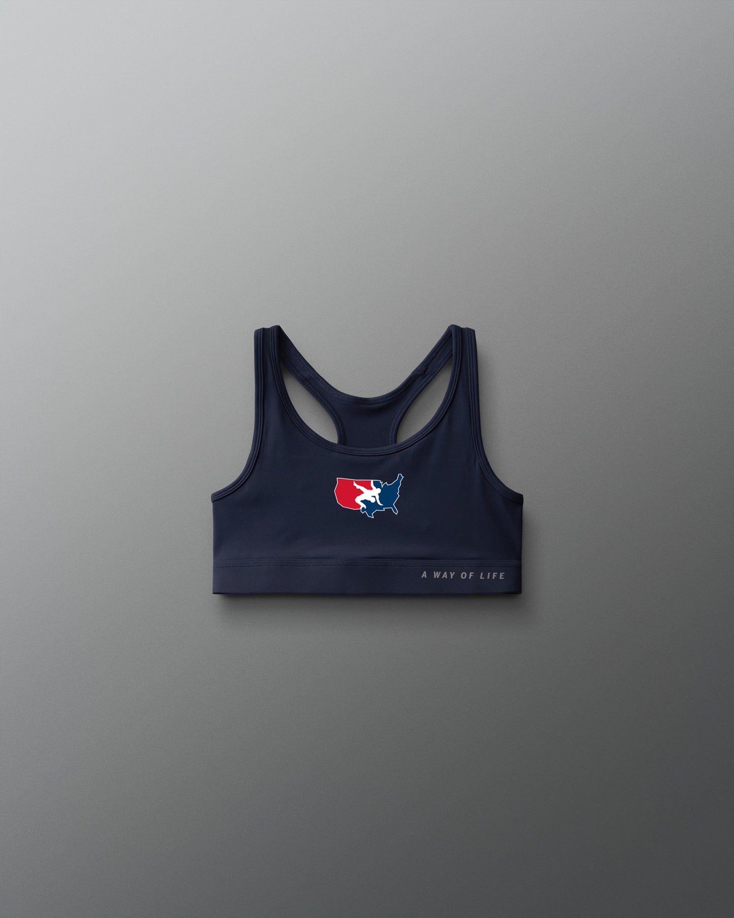 Navy sports bra with logo on a gray background