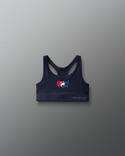 Navy sports bra with logo on a gray background
