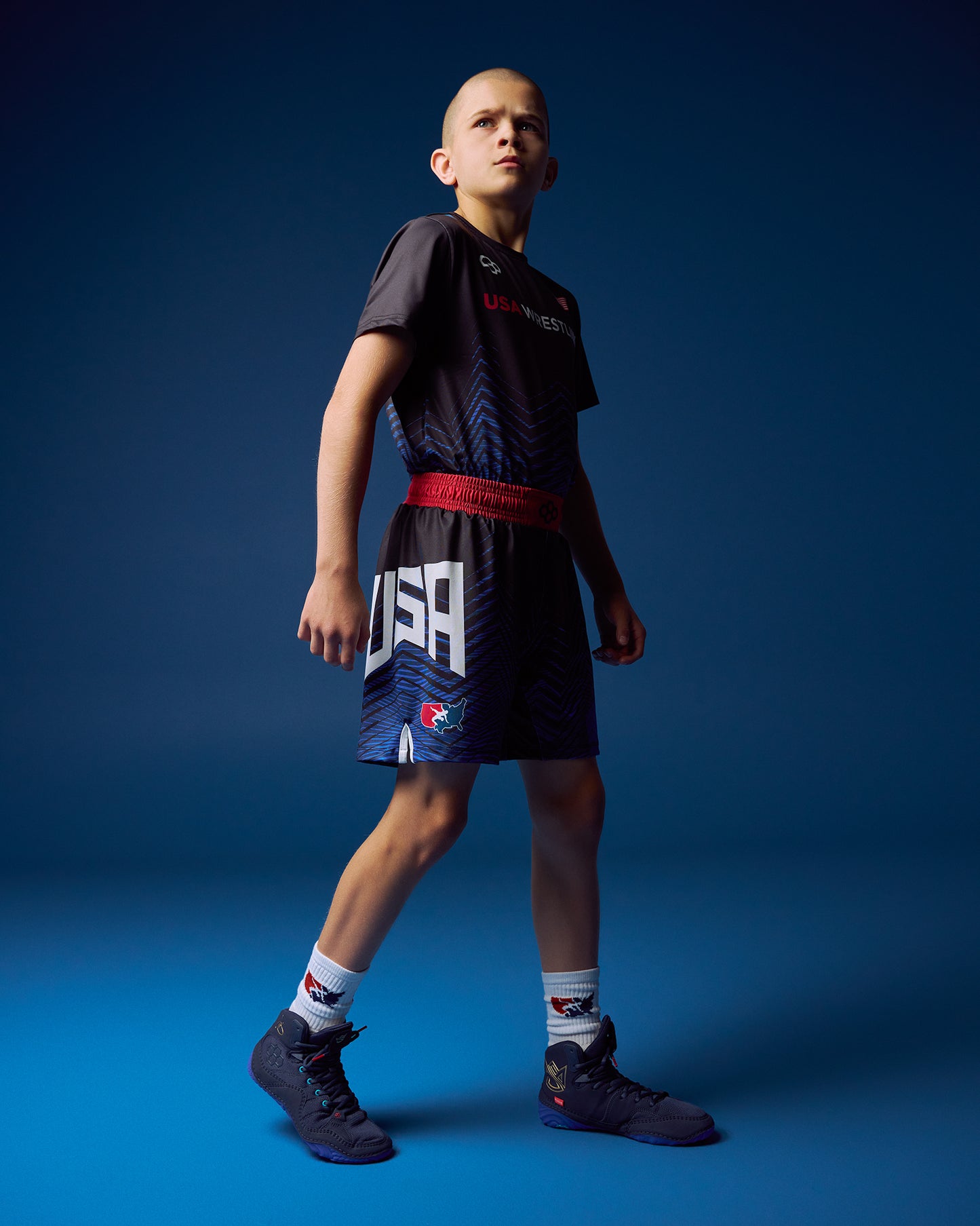 Person wearing a sports outfit with 'USA' on shorts against a blue background