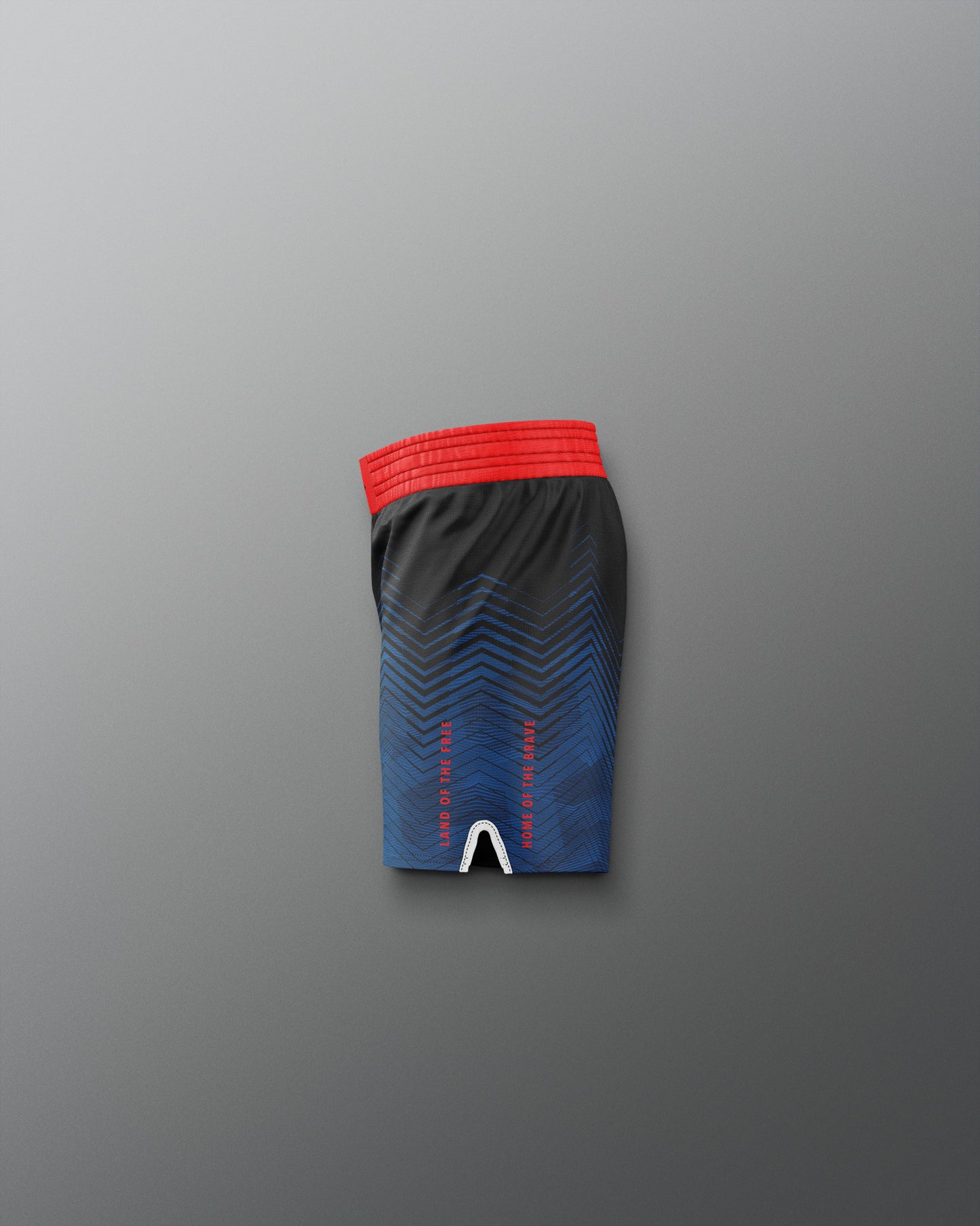 Black athletic shorts with red waistband on a gradient blue and red background