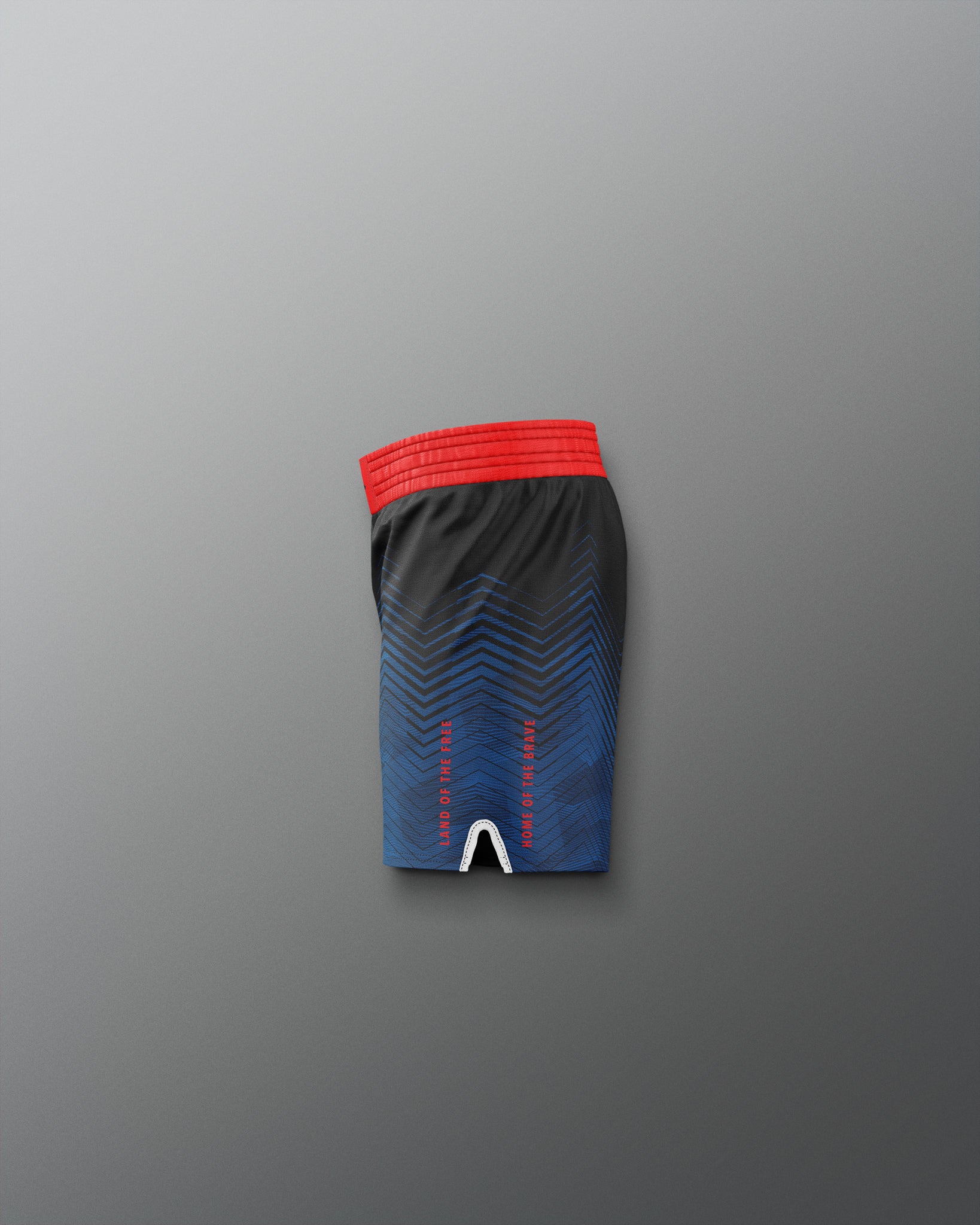 Black athletic shorts with red waistband on a gradient blue and red background