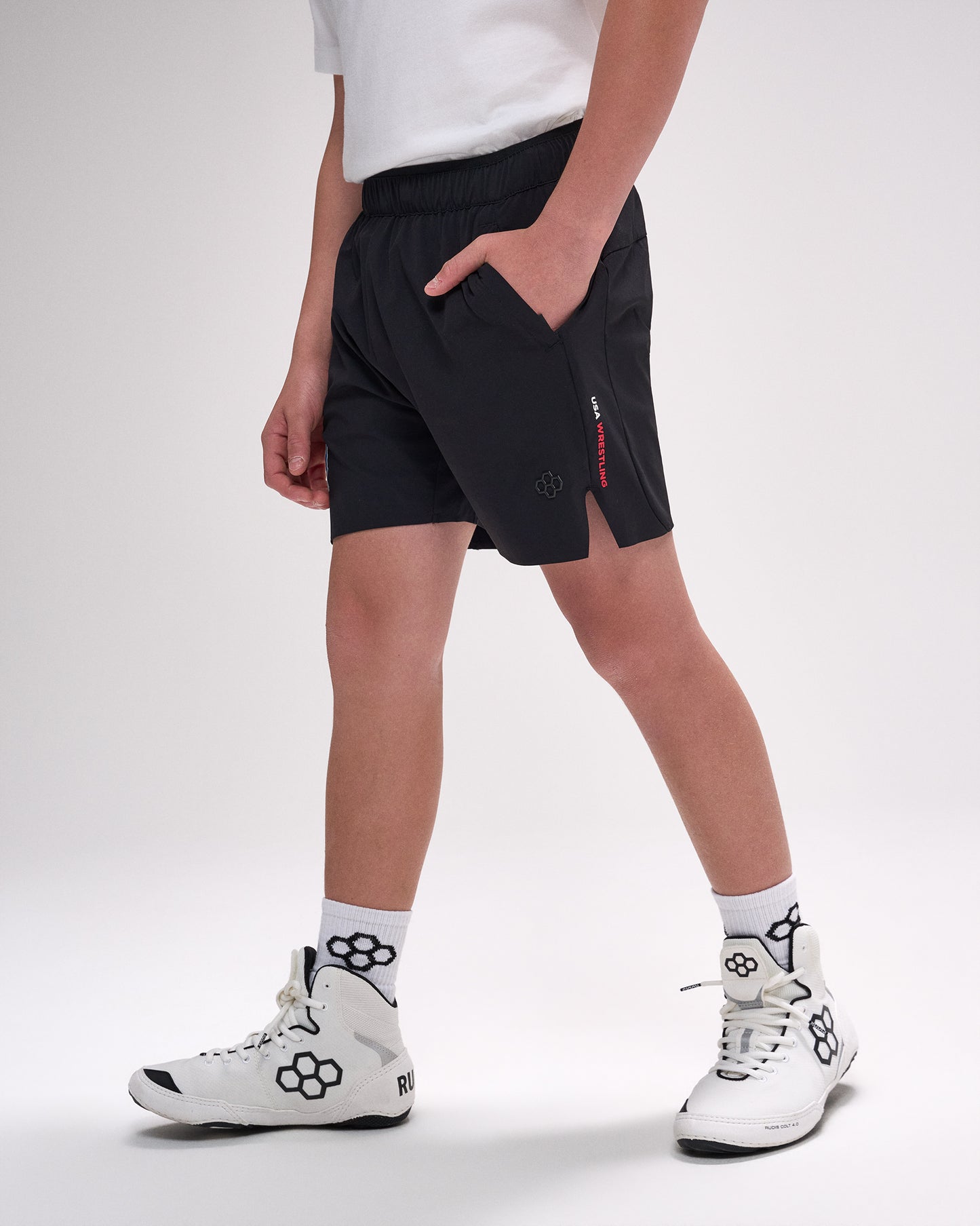 Person wearing black shorts with a red zipper on a white background
