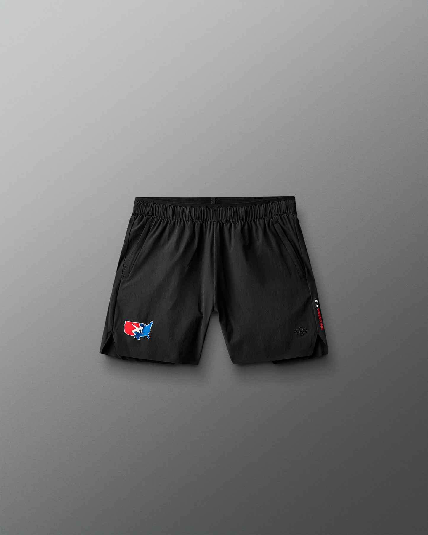 Black shorts with a USa Wrestling logo on a gray background