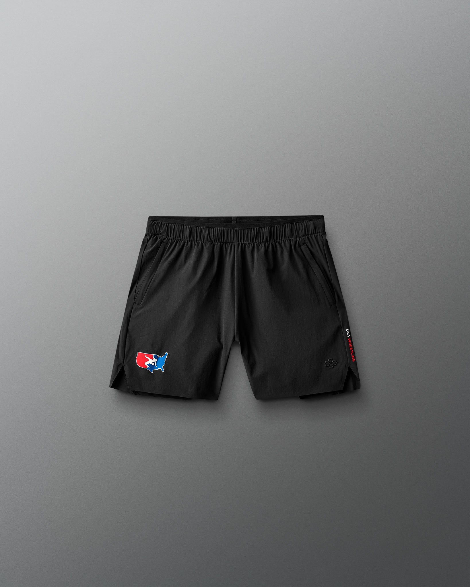 Black shorts with a USa Wrestling logo on a gray background
