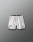 White athletic shorts with USA Wrestling and RUDIS  logos on a gray background