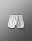 White shorts with a brand logo on a gray background