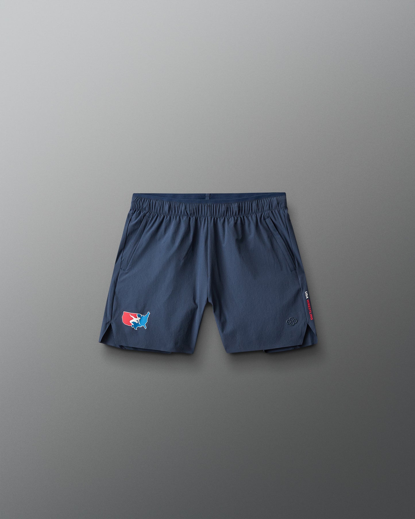 Navy blue shorts with a USA Wrestling  logo on a gray background