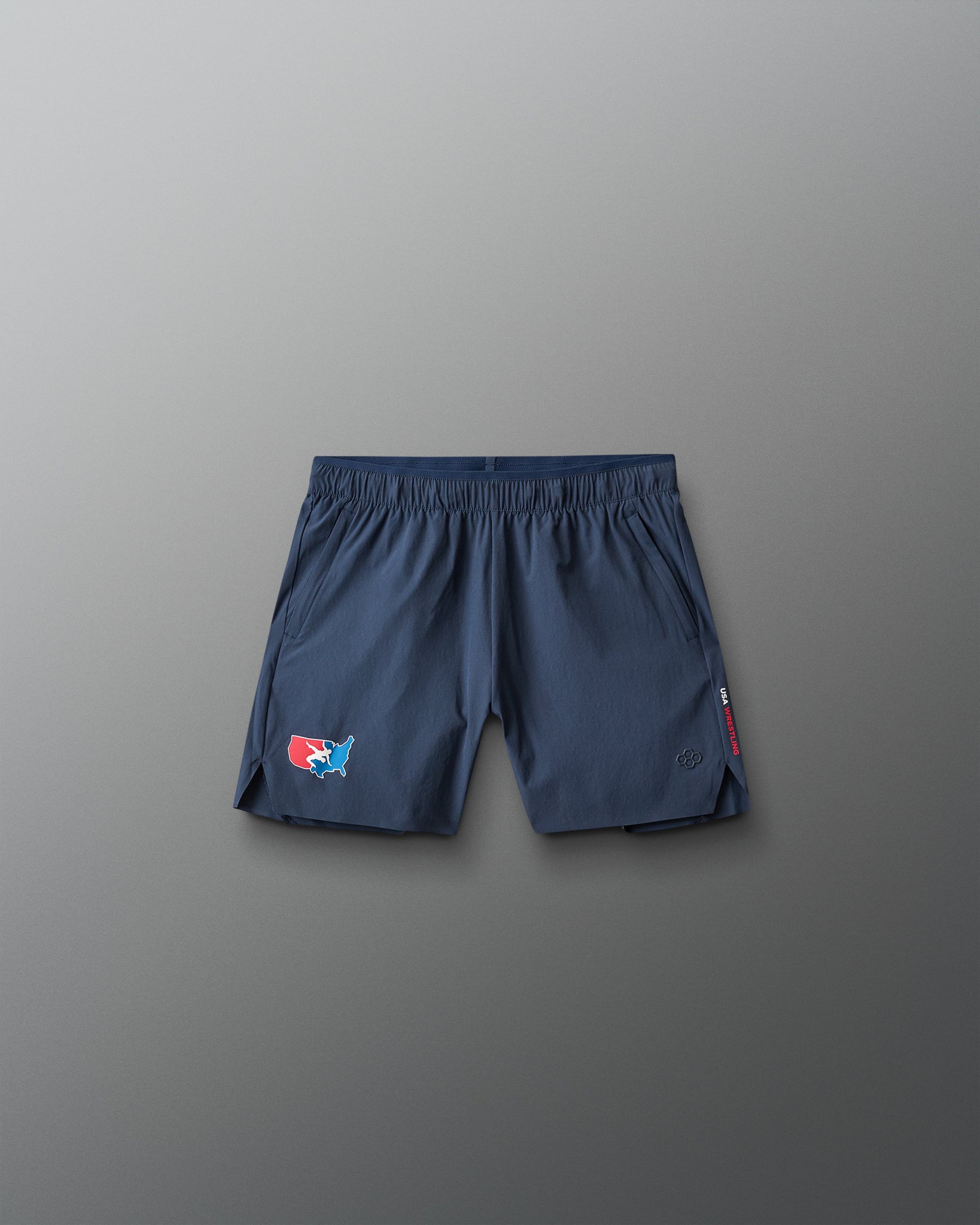 Navy blue shorts with a USA Wrestling  logo on a gray background