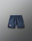Navy blue shorts with a USA Wrestling  logo on a gray background