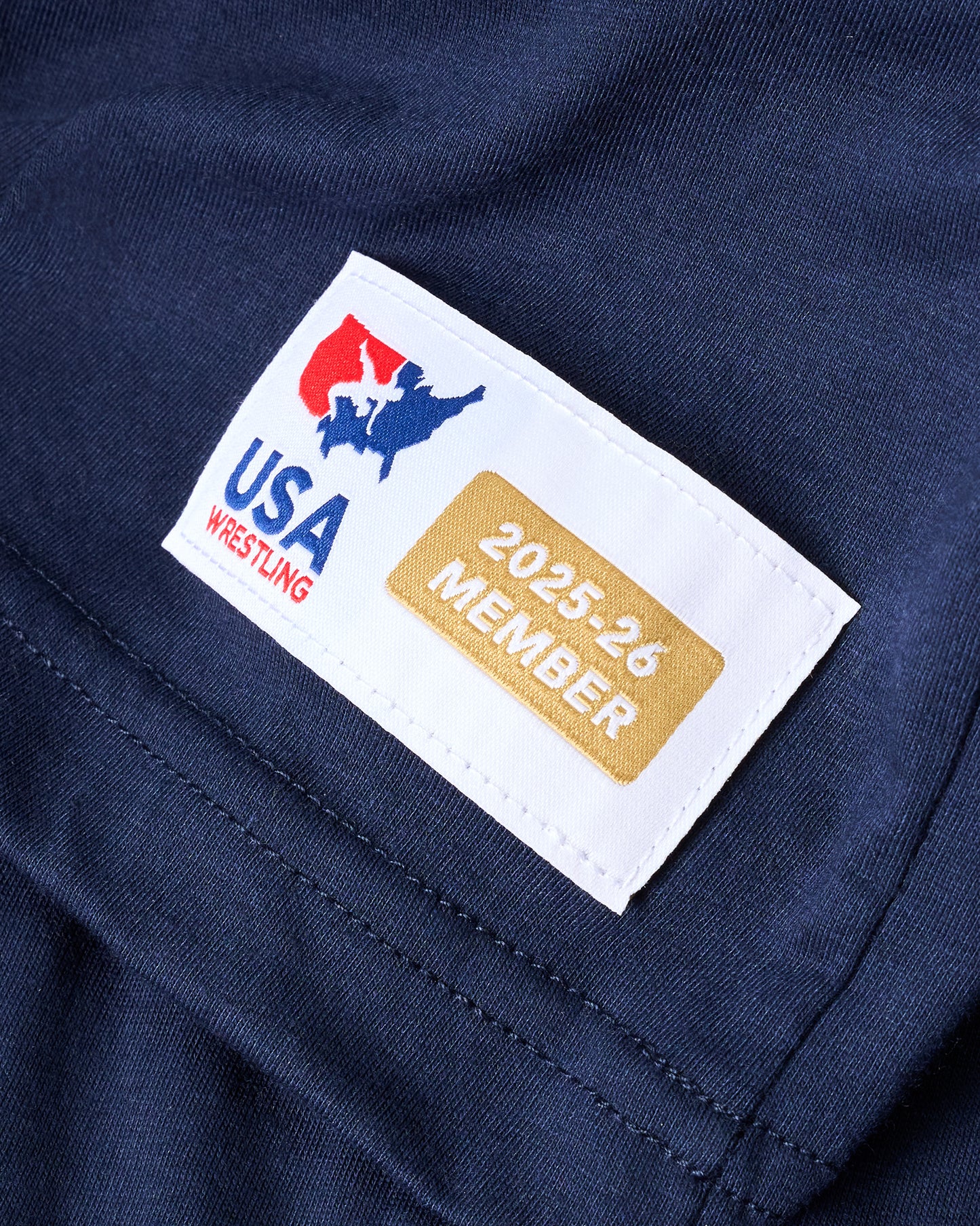 USA Wrestling member tag on a navy blue background