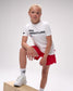 Child wearing a USA Wrestling t-shirt and red shorts on a white background