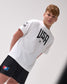 Person wearing a white t-shirt with 'USA' text and black shorts on a light gray background