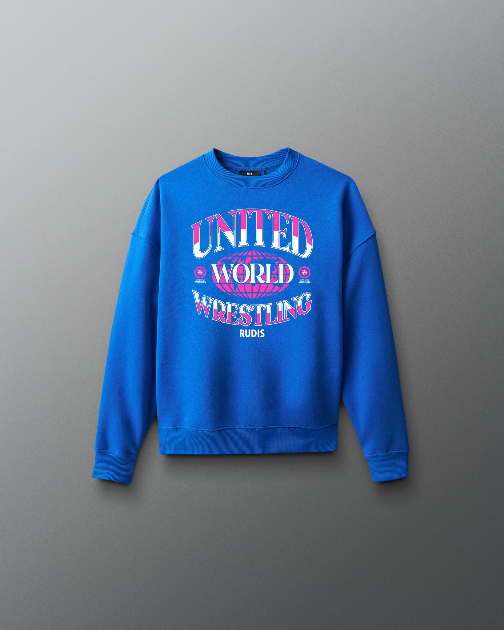 Youth royal blue RUDIS UWW Globe Relaxed Comfort Fleece Crewneck shown from the front, featuring a bold pink-and-white “UNITED WORLD WRESTLING” globe graphic across the chest with RUDIS branding below.