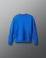 Back view of the youth royal blue RUDIS UWW Globe Relaxed Comfort Fleece Crewneck, featuring a clean tonal finish with subtle RUDIS branding below the back neckline and a tonal RUDIS mark on the sleeve.