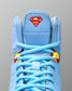 Close-up of RUDIS JB1 Superman wrestling shoe tongue featuring the red and yellow Superman shield above light blue laces.