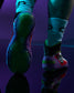 Close-up of a person's legs wearing colorful RUDIS wrestling shoes and white crew socks, with one shoe showing the sole and the other showing the side against a dark purple background.
