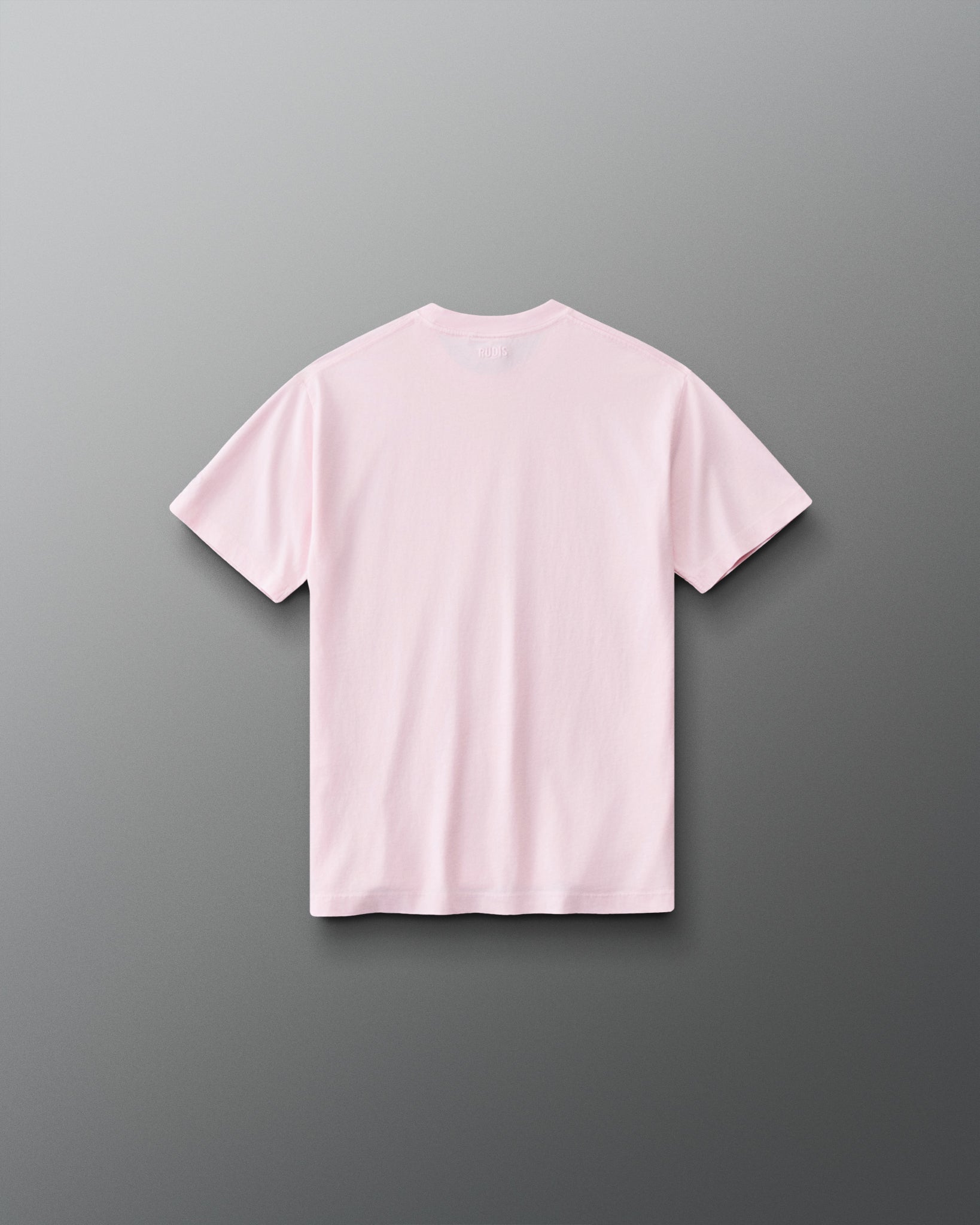 Back view of RUDIS Wonder Woman Girl Power Youth Relaxed Cotton T-Shirt in washed pink, showcasing a clean back design, subtle RUDIS branding below the collar and relaxed short-sleeve silhouette.