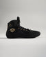A stylish black athletic shoe featuring gold accents and a unique hexagonal logo design ideal for performance and casual wear